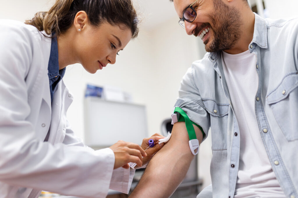 A photo of a blood test by female doctor on a patient's arm