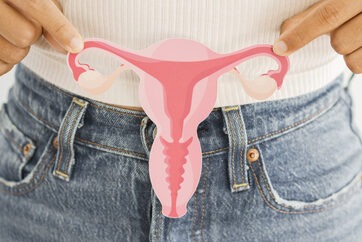 Woman hands holding a picture of an uterus