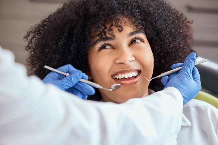 Above shot of a young woman with looking at the dentist at her dental appointment.