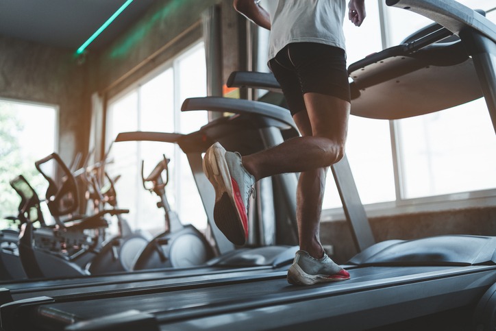 Close up of feet, sportman runner running on treadmill