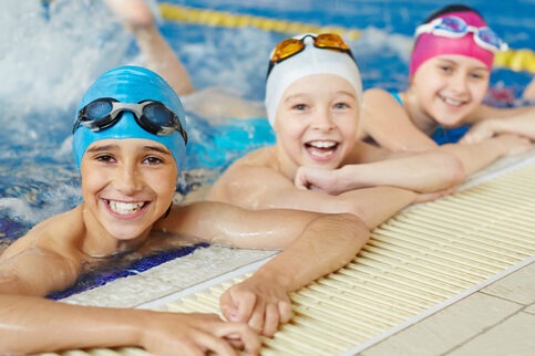 Happy group of children swimming together