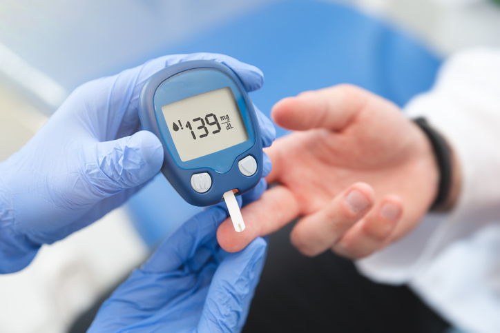 A patient receiving a glucose test from a medical professional