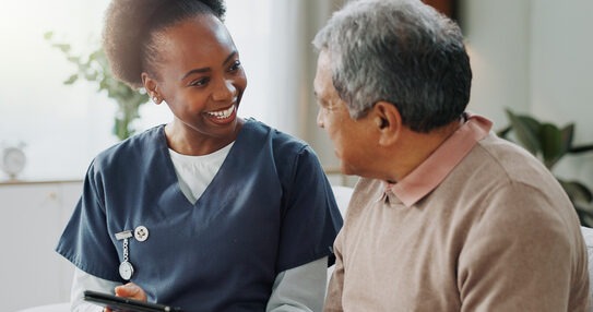 Tablet, healthcare and nurse in home with senior man on sofa.