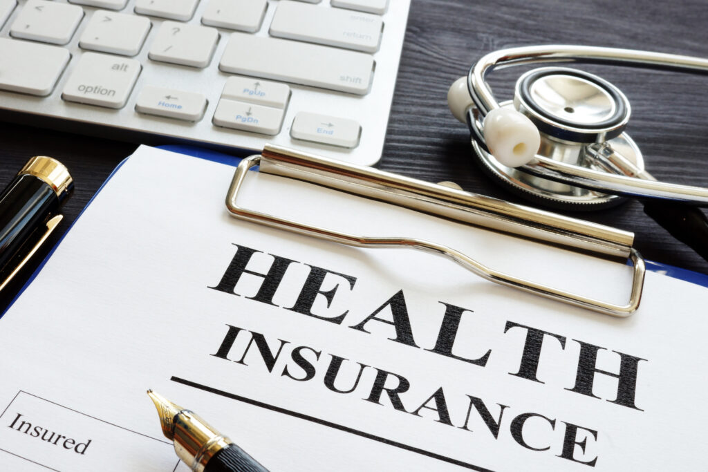 Button to learn more about accepted insurance plans consisting of a photo of an Individual health insurance policy and stethoscope.