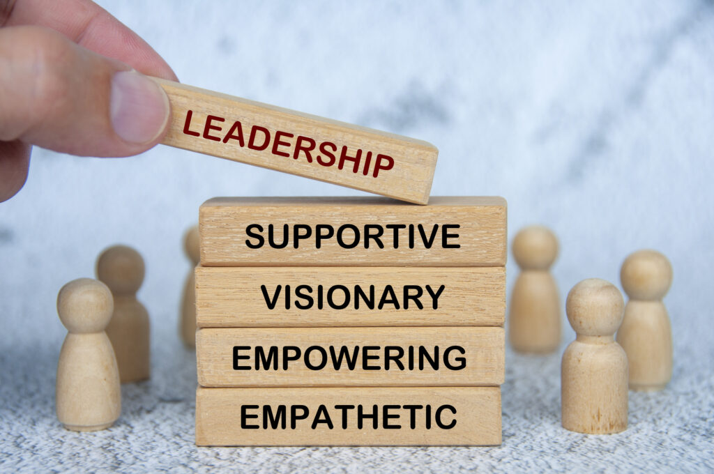 Button for more information on MCHD leadership consisting of a graphic of LEADERSHIP, SUPPORTIVE, VISIONARY, EMPOWERING and EMPATHETIC text on wooden blocks.