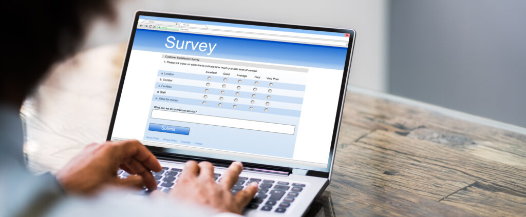 A photo of an online survey form with a man filling out the form