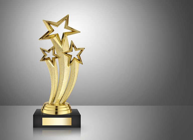 Golden star trophy on gray background