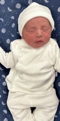 A photograph of a newborn baby
