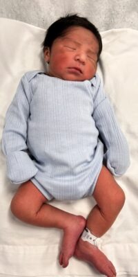 A photograph of a newborn baby